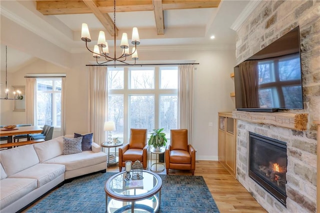 living room featuring a large fireplace, beamed ceiling, wood finished floors, and a notable chandelier