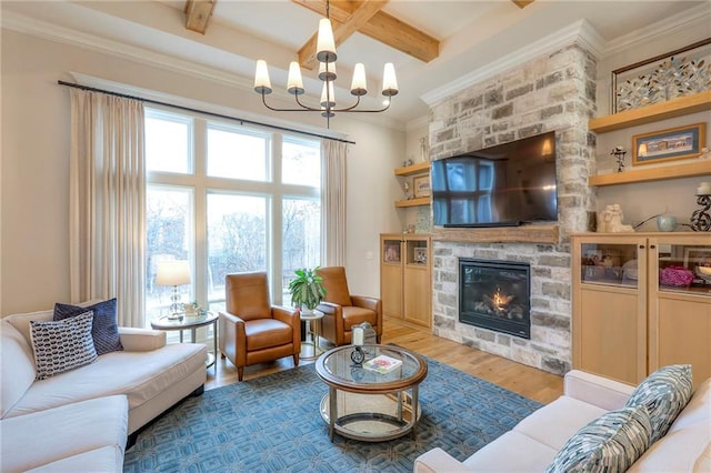 living area featuring crown molding, a large fireplace, wood finished floors, a chandelier, and beamed ceiling