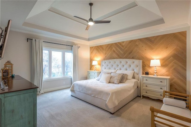 bedroom with ceiling fan, light carpet, baseboards, a raised ceiling, and crown molding