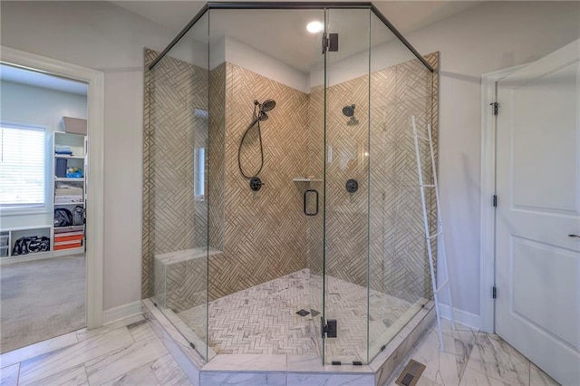 bathroom with marble finish floor, baseboards, visible vents, and a shower stall