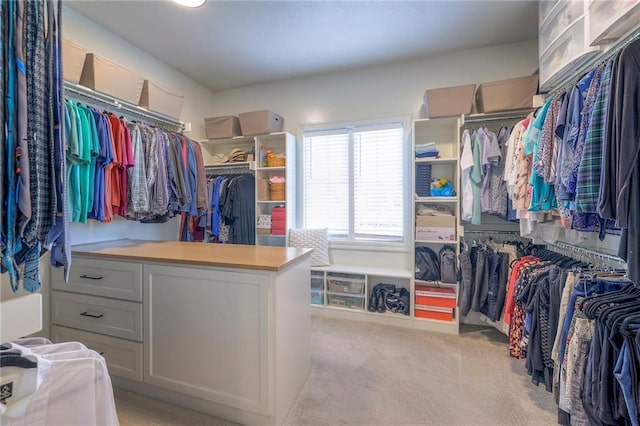 walk in closet featuring light carpet