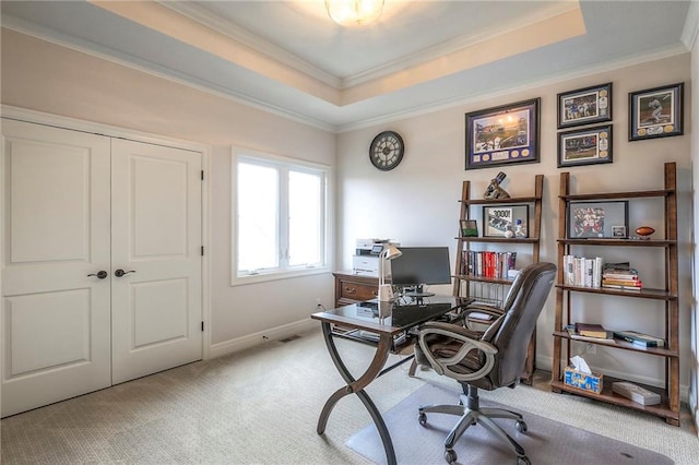 office with baseboards, a tray ceiling, crown molding, and light colored carpet