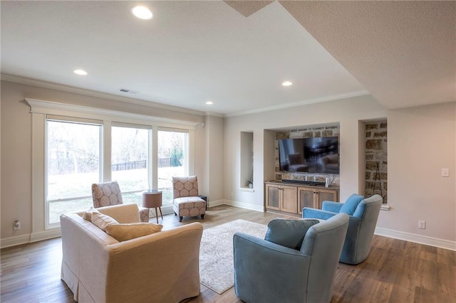 living room featuring a healthy amount of sunlight, visible vents, and wood finished floors