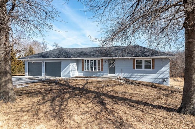 ranch-style home featuring an attached garage and driveway