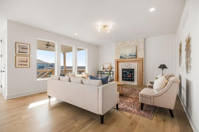 living area featuring visible vents, recessed lighting, a fireplace, light wood finished floors, and baseboards
