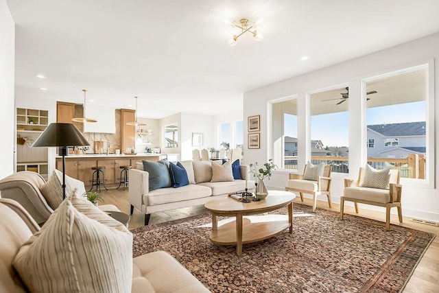 living area featuring visible vents, recessed lighting, light wood-type flooring, and ceiling fan