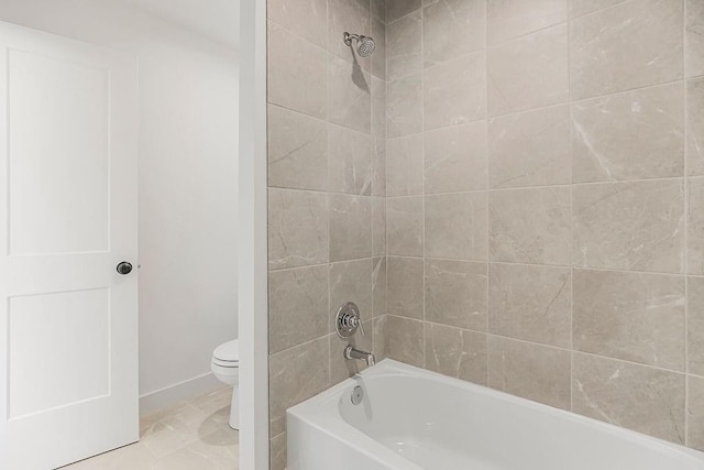 bathroom with bathing tub / shower combination and toilet