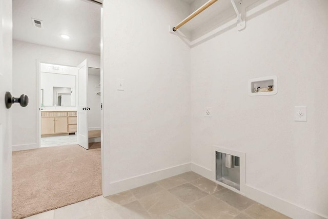 laundry area featuring visible vents, baseboards, laundry area, washer hookup, and light carpet