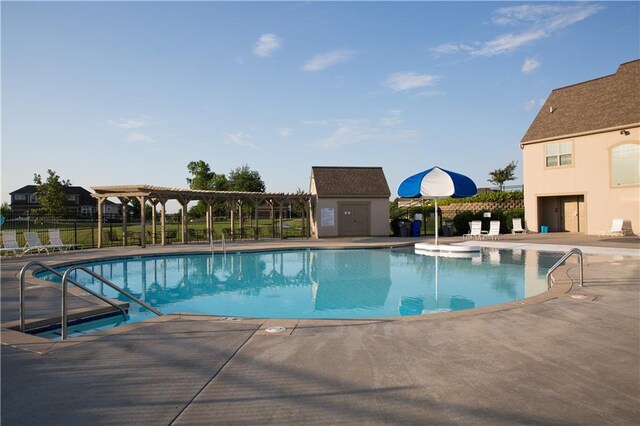 pool featuring a patio, a pergola, and fence