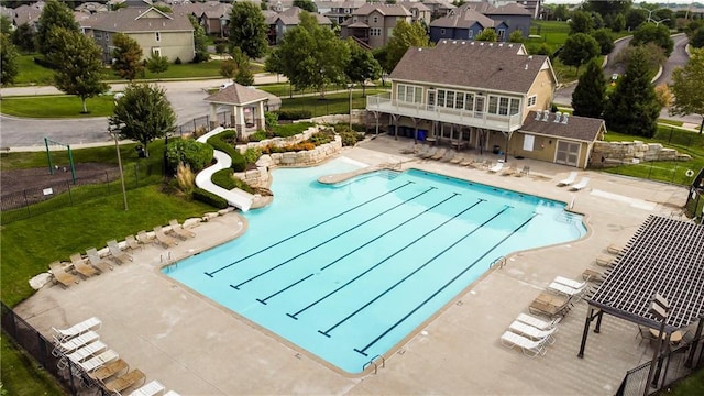 pool with fence, a residential view, a gazebo, a patio area, and a lawn