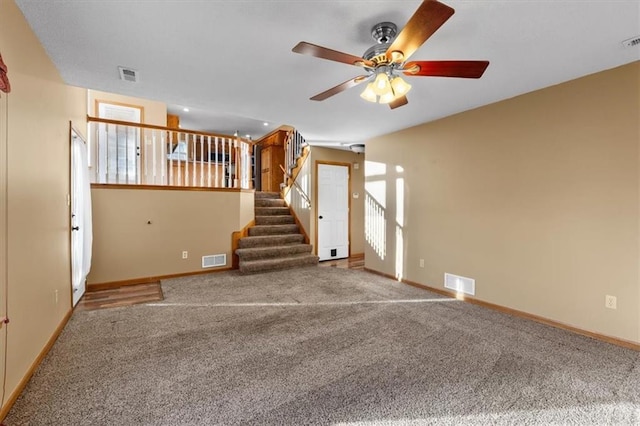 interior space featuring stairs, visible vents, and baseboards