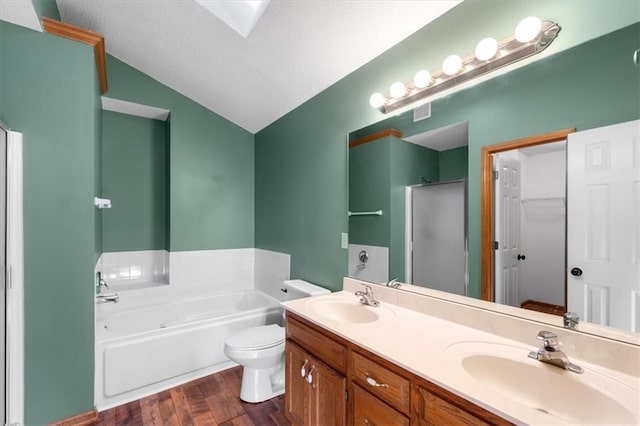 full bathroom with lofted ceiling, a garden tub, a sink, and wood finished floors