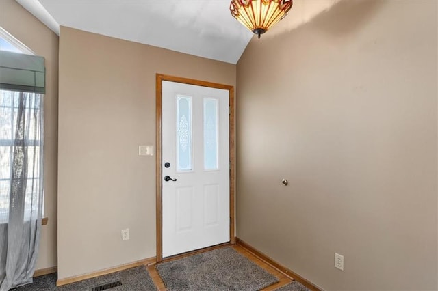 doorway to outside with baseboards and visible vents