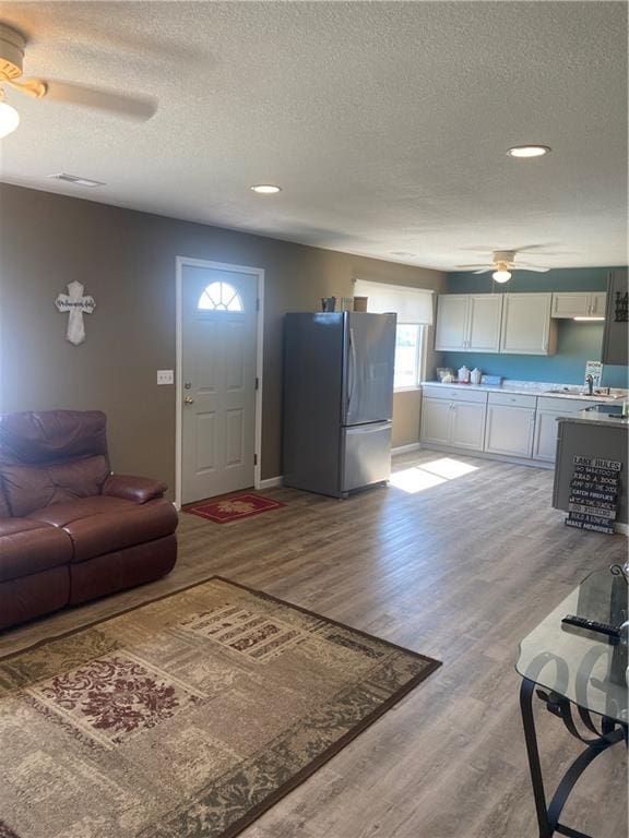 200 Ramsey Dr, Craig, MO 64437 - living area featuring visible vents, ceiling fan, a textured ceiling, and wood finished floors