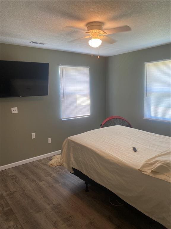 200 Ramsey Dr, Craig, MO 64437 - bedroom featuring baseboards, visible vents, ceiling fan, wood finished floors, and a textured ceiling