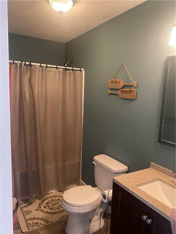 200 Ramsey Dr, Craig, MO 64437 - full bath featuring toilet, curtained shower, a textured ceiling, and vanity