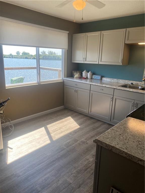 200 Ramsey Dr, Craig, MO 64437 - kitchen with a ceiling fan, light wood-type flooring, a water view, and baseboards