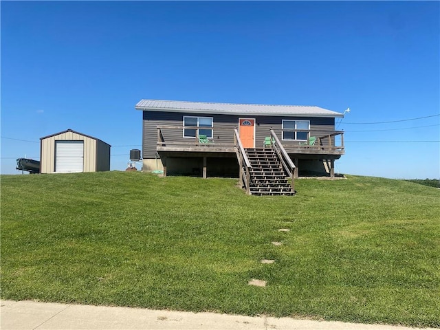 200 Ramsey Dr, Craig, MO 64437 - view of front of property featuring a storage unit, stairway, a front yard, an outdoor structure, and a wooden deck