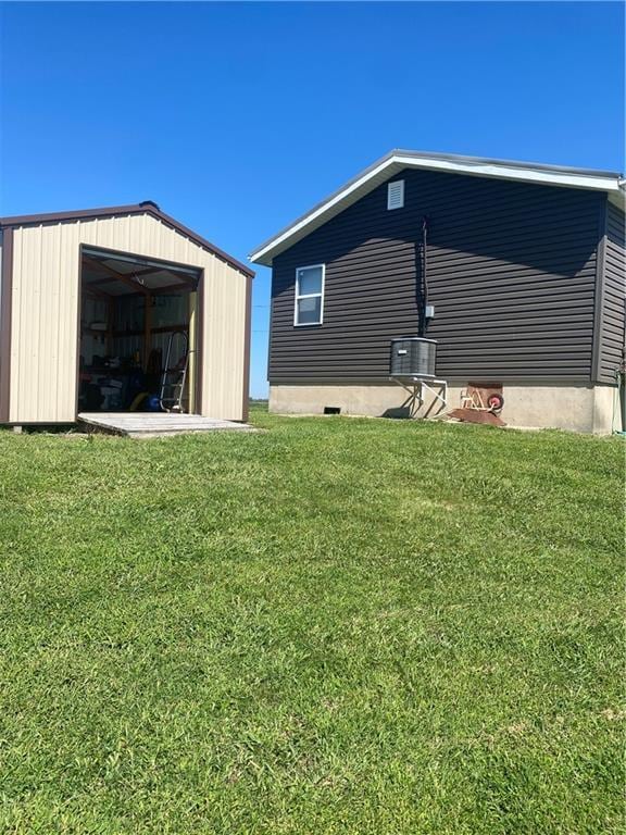 200 Ramsey Dr, Craig, MO 64437 - exterior space with central AC unit, a pole building, a lawn, and an outbuilding