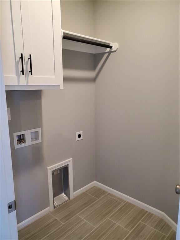 washroom featuring hookup for an electric dryer, washer hookup, baseboards, cabinet space, and wood tiled floor