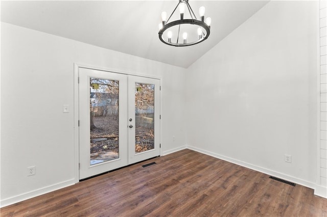 unfurnished dining area with lofted ceiling, french doors, visible vents, and wood finished floors