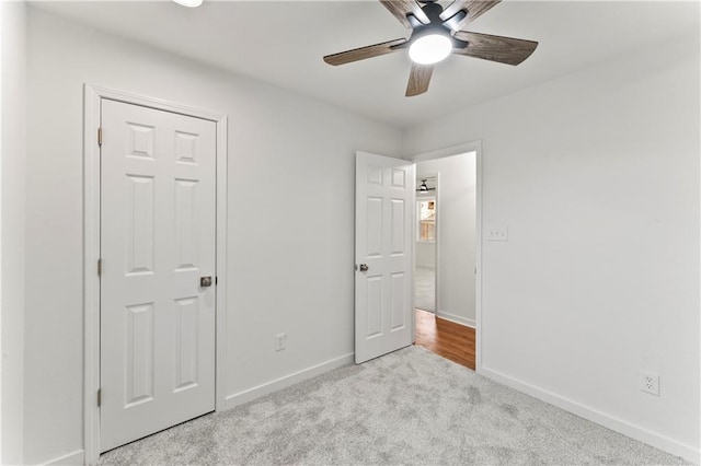 unfurnished bedroom with carpet flooring, ceiling fan, and baseboards