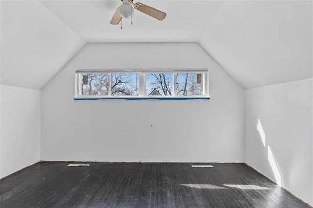 additional living space with lofted ceiling, dark wood-style flooring, and a healthy amount of sunlight