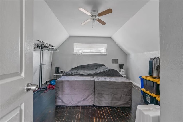 bedroom featuring visible vents, dark wood-type flooring, a ceiling fan, vaulted ceiling, and baseboards