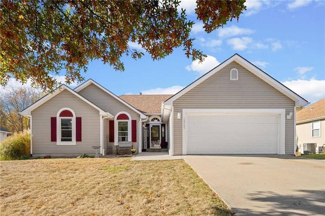 single story home with a garage, cooling unit, a front lawn, and concrete driveway