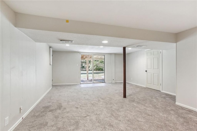 below grade area with carpet floors, baseboards, and visible vents