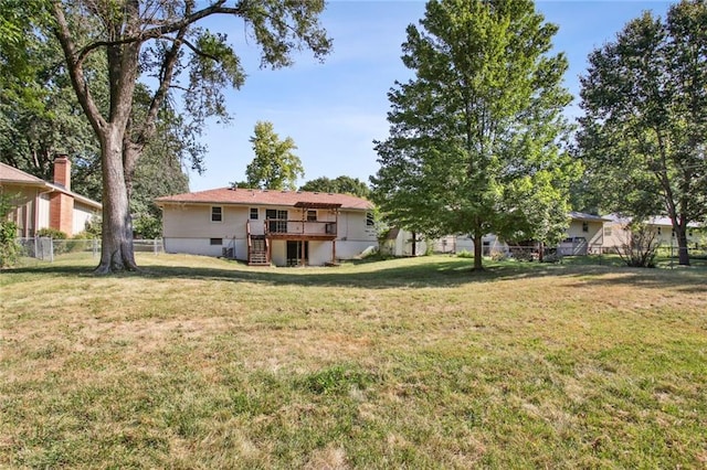 view of yard with fence, stairway, and a wooden deck