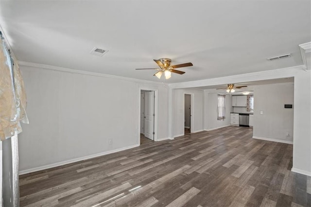 unfurnished living room with dark wood-style floors, ornamental molding, and visible vents