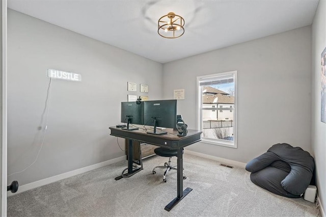 carpeted office space with visible vents and baseboards