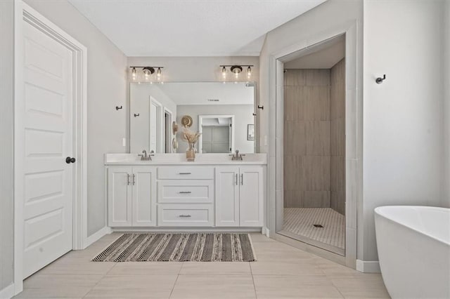 full bath with double vanity, a soaking tub, a shower stall, and a sink