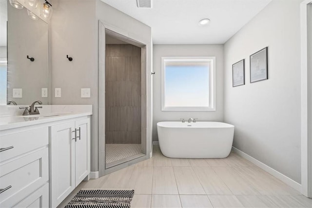 bathroom with visible vents, baseboards, a soaking tub, vanity, and a shower stall