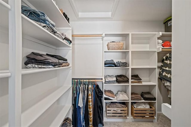 spacious closet with carpet and attic access