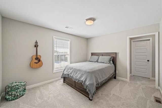 bedroom with carpet, visible vents, and baseboards