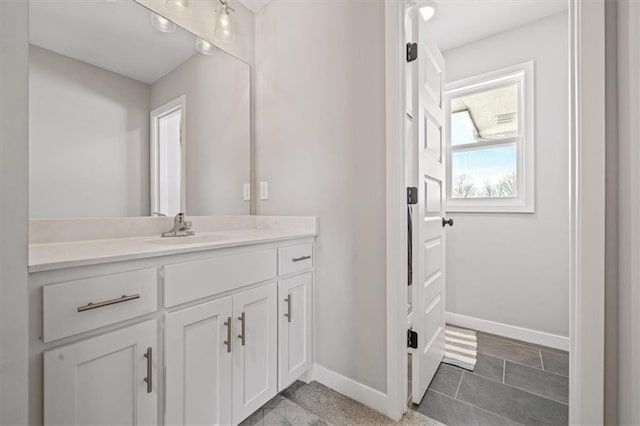 bathroom featuring vanity and baseboards