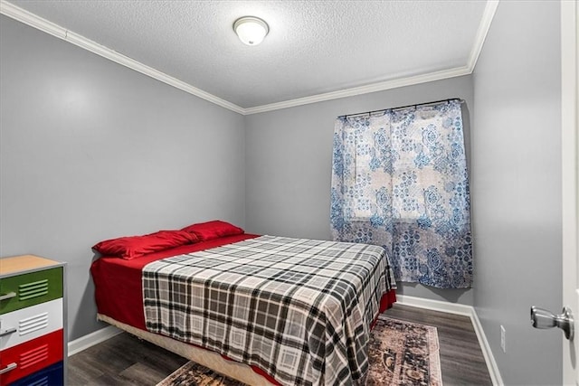 bedroom featuring dark wood-style floors, a textured ceiling, baseboards, and crown molding