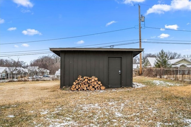 view of shed featuring fence