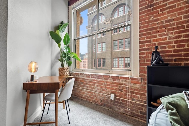 home office with brick wall, carpet, and a view of city