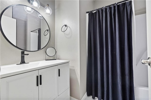 full bathroom featuring vanity and shower / bath combo with shower curtain