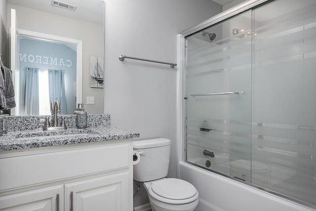 full bath featuring enclosed tub / shower combo, visible vents, vanity, and toilet