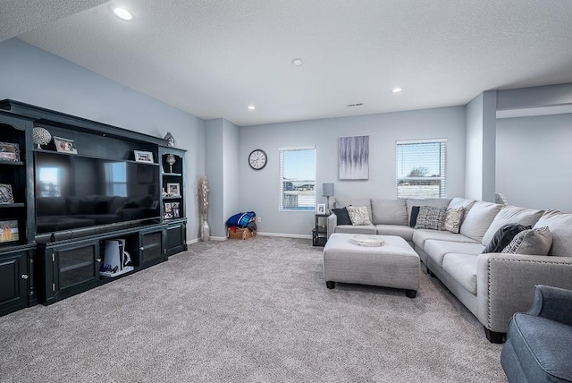 living area featuring carpet, baseboards, a textured ceiling, and recessed lighting