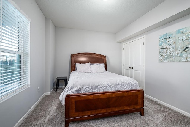 carpeted bedroom featuring baseboards