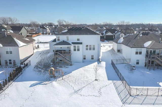 snowy aerial view with a residential view