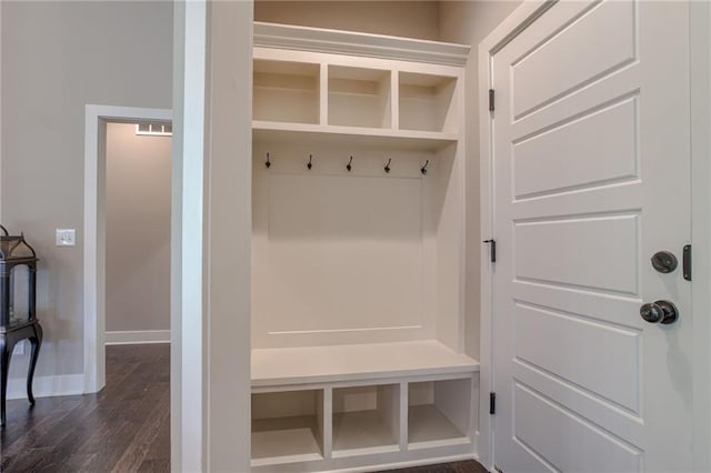 mudroom with dark wood-type flooring and baseboards