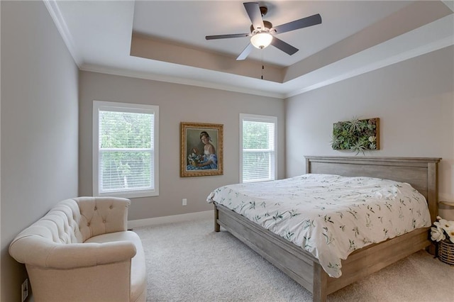 bedroom with baseboards, a raised ceiling, crown molding, and light colored carpet