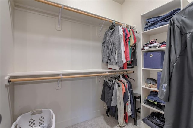 walk in closet featuring light colored carpet