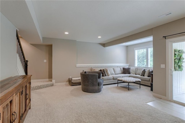 living room featuring recessed lighting, visible vents, stairway, light carpet, and baseboards